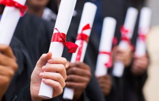 Row of university graduates holding their scrolls. Image: Thinkstock