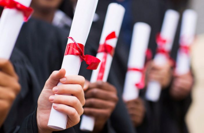 Row of university graduates holding their scrolls. Image: Thinkstock