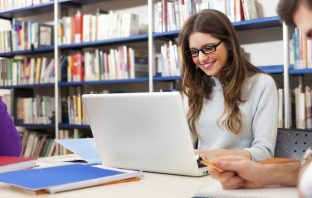 Girl doing computer research in a library. Image credit: Thinkstock