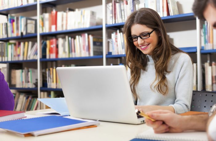 Girl doing computer research in a library. Image credit: Thinkstock