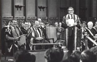 The Open University Chancellor Asa Briggs addressing the audience at a graduation ceremony.