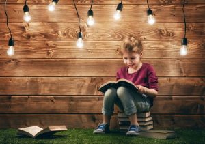 Cute little child girl reading a book. Image credit: Thinkstock