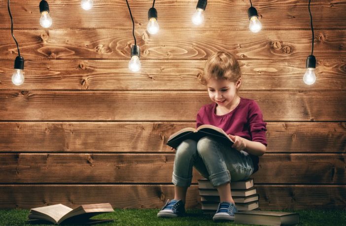 Cute little child girl reading a book. Image credit: Thinkstock