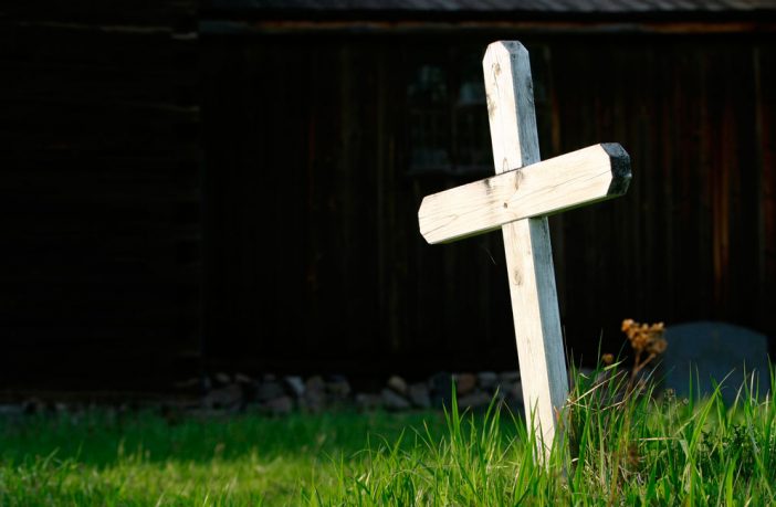 Wooden cross in a graveyard. Image credit: Thinkstock