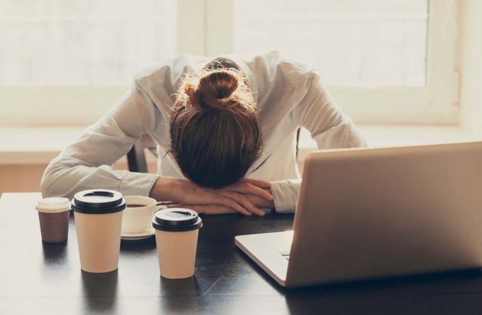 Business woman resting her head on her desk. Image credit: Thinkstock