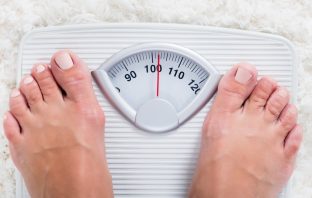 Feet of female - obese - on weighing scales