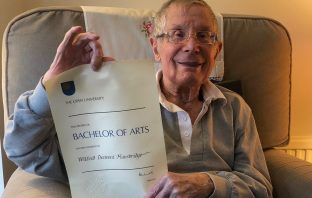 Wilfred Mansbridge holding his OU degree certificate