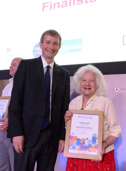 Sylvia and her award, pictured with Stephen Evans, Festival of Learning Director