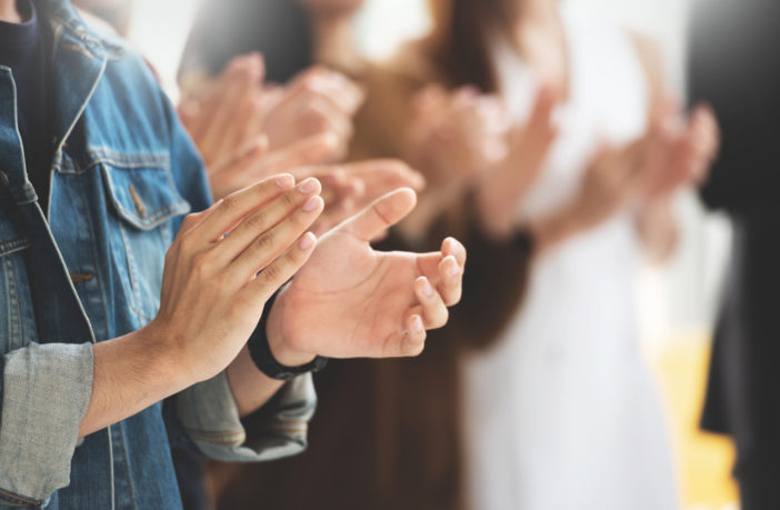 Photograph of people's hands clapping