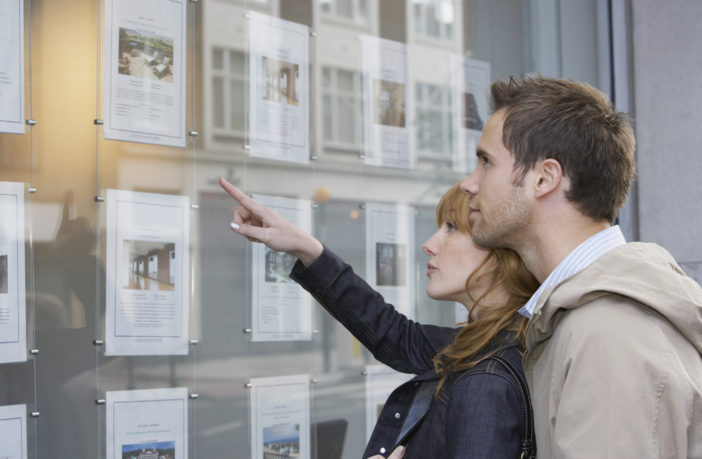 couple looking in estate agents
