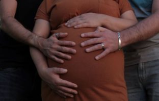 Pregnant woman with hands on her stomach