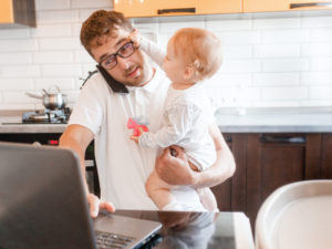 Man at laptop with baby