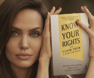 Actress, Angelina Jolie holding a copy of the book, Know Your Rights and Claim Them