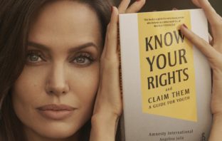Actress, Angelina Jolie holding a copy of the book, Know Your Rights and Claim Them