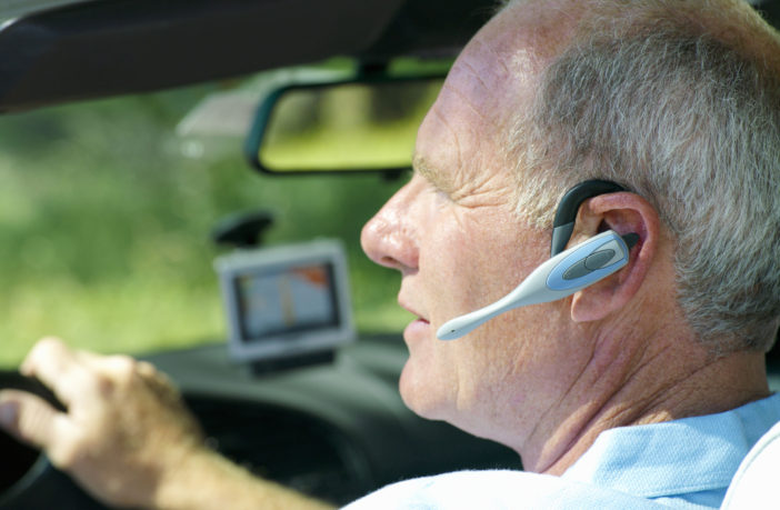 man driving while on phone