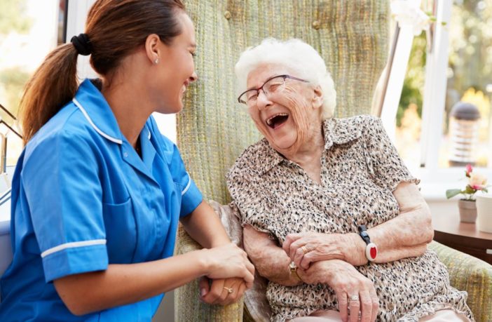 Nurse laughing with an older woman