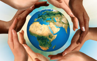 Hands surrounding a globe