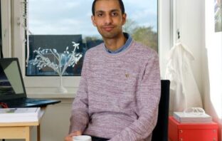 OU graduate Ali shows where he achieved his degree through supported distance learning