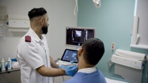 A sonographer treating a patient