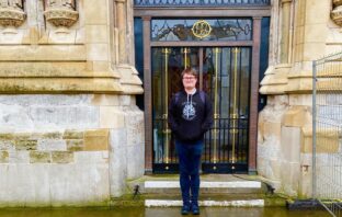 Martyn standing outside an ornate building wearing an OU hoodie.