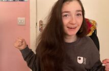 Young girl with long dark hair wearing an OU jumper