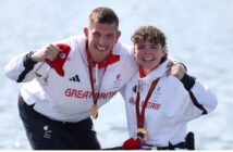 Gregg and rowing partner Lauren wearing Team GB kit, smiling at the camera with Paralympic Gold medals around their necks.